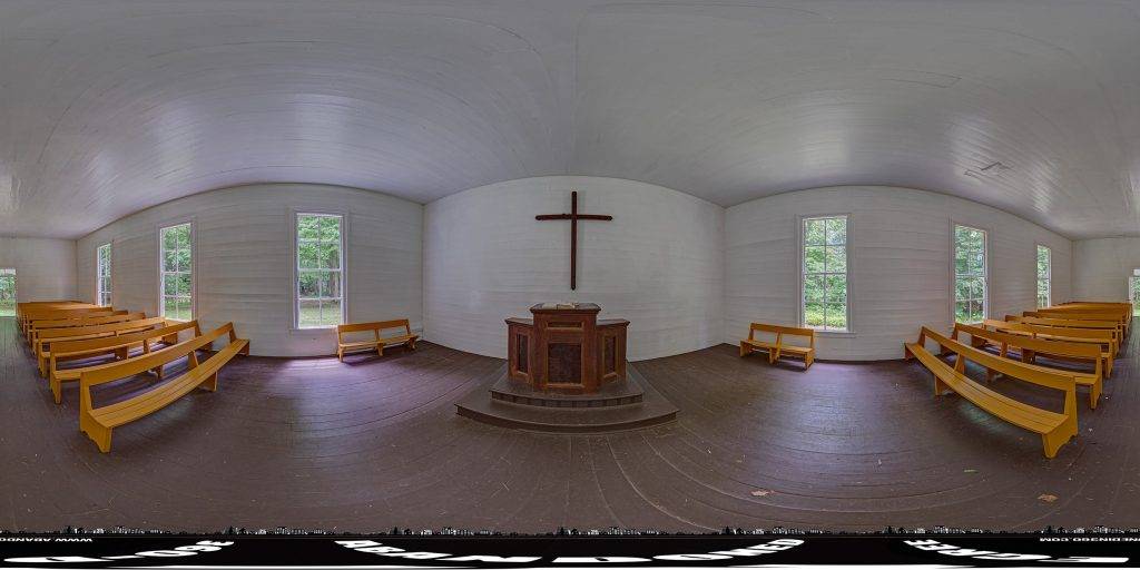 A 360-degree panoramic image captured inside the historic Palmer Chapel Methodist Church in Cataloochee, North Carolina.