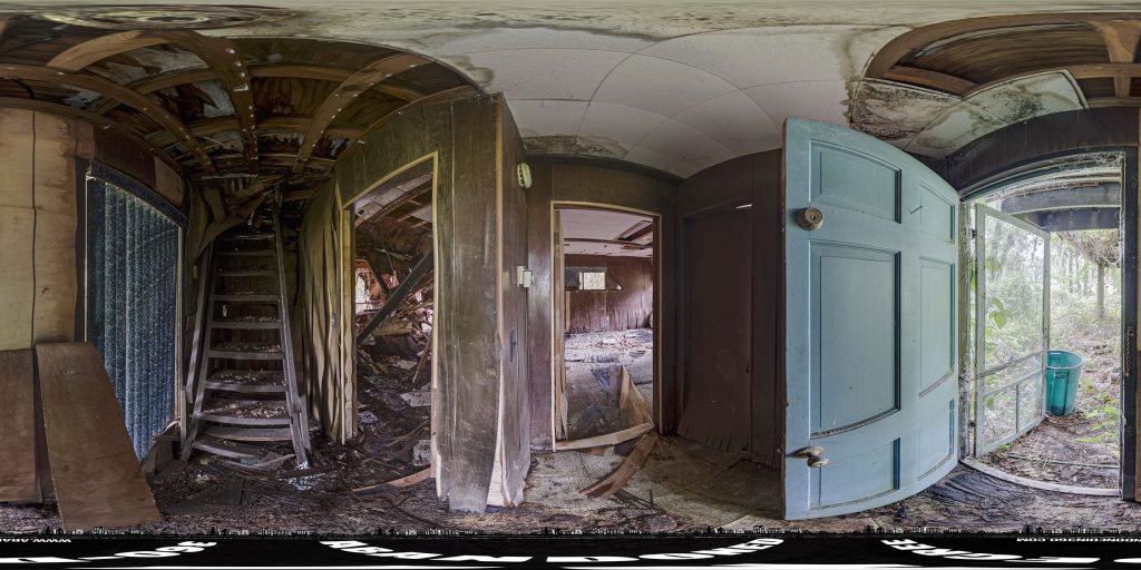 A 360-degree panoramic image of an abandoned A-Frame style home in Central Florida.