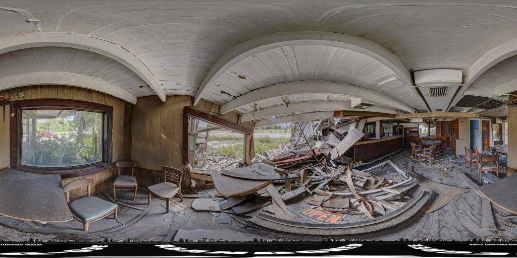 A 360-degree panoramic image captured inside the historic and abandoned Desert Inn Bar and Restaurant in Central Florida.