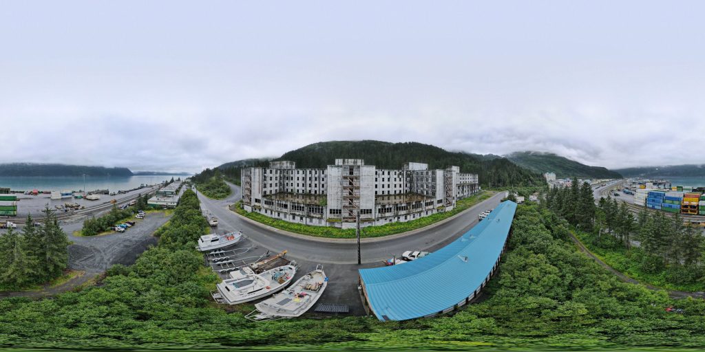 An aerial 360-degree panoramic image captured outside the abandoned Buckner Building in Whittier, Alaska. 