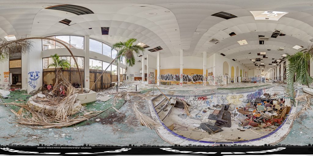 A 360-degree spherical panoramic image capturing the immense vandalism and state of decay of the Cristal Palace Resort in Florida.