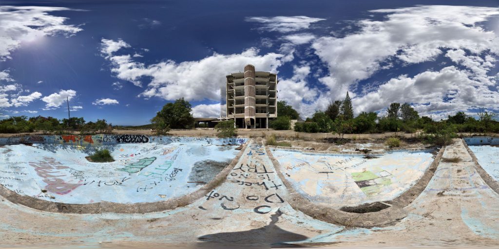 A 360-degree panoramic image capturing the decaying exterior of the Hotel Ponce Intercontinental in Ponce, Puerto Rico. Image by: Winston G